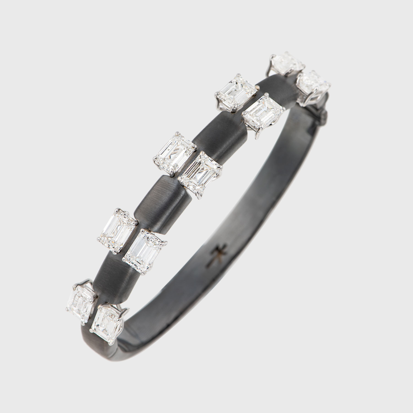 Blackened white gold tennis bracelet with emerald cut white diamonds