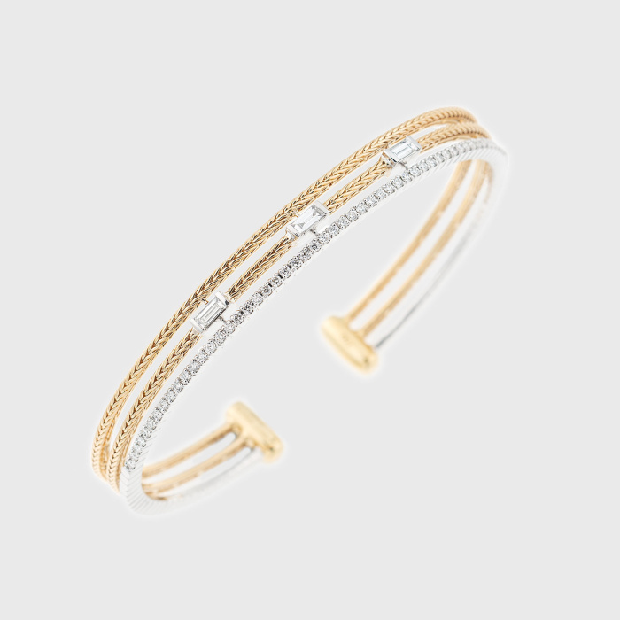 Yellow gold bangle bracelet with white diamond baguettes and paved white diamonds
