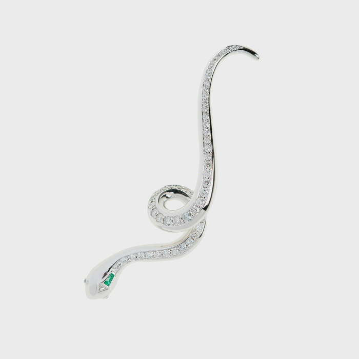 White gold snake earcuff with white diamonds, emerald and black diamond