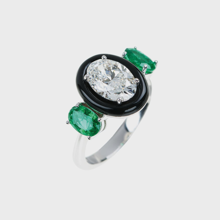 White gold ring with oval white diamond, oval emeralds and black enamel