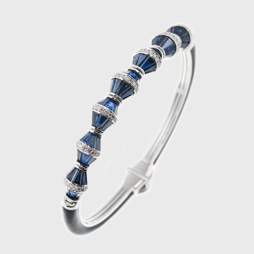 White gold bracelet with tapered blue sapphires, white diamonds and black enamel